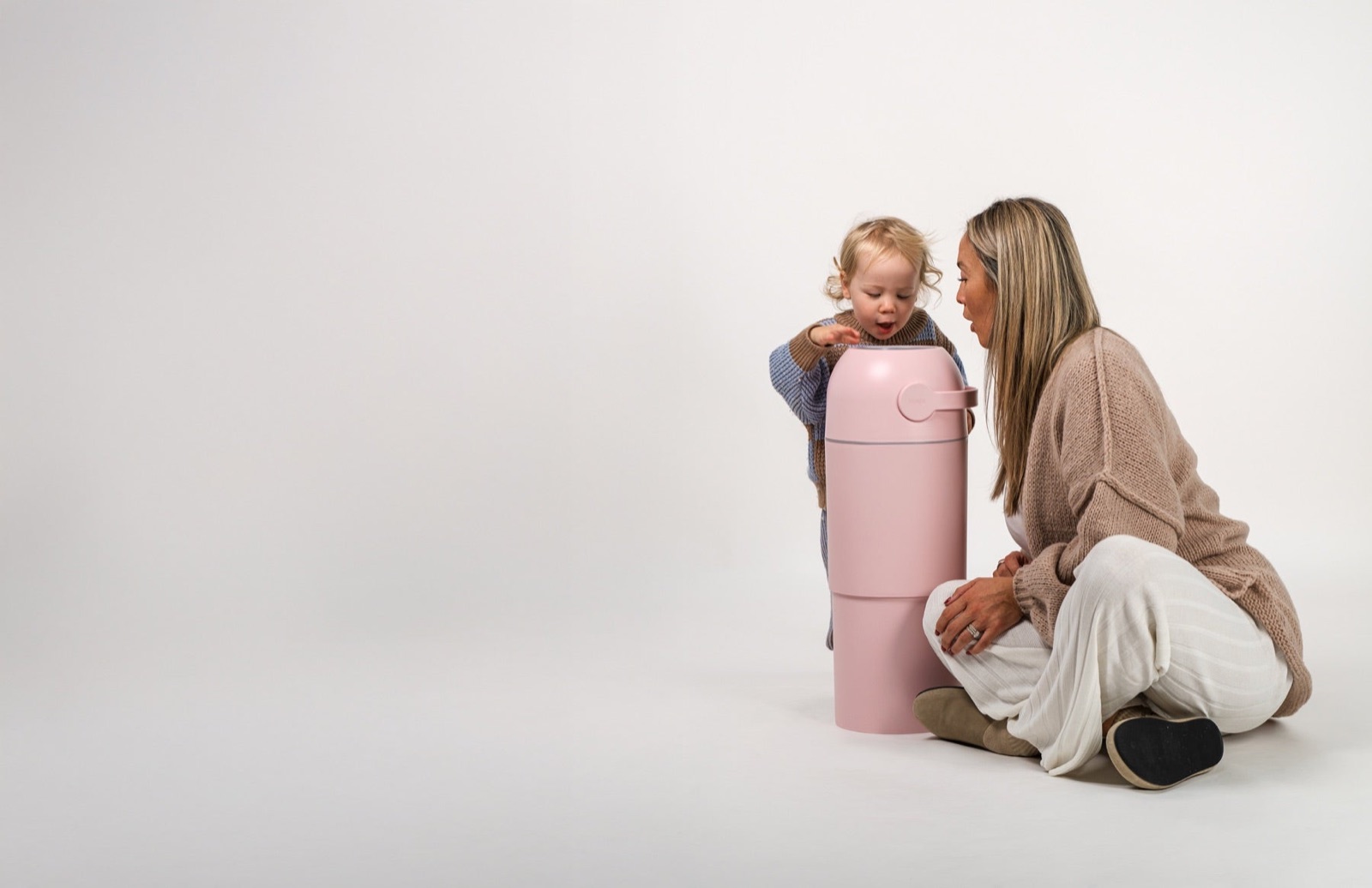 A parent and toddler with a Blush Pink Magic Thoth L nappy bin