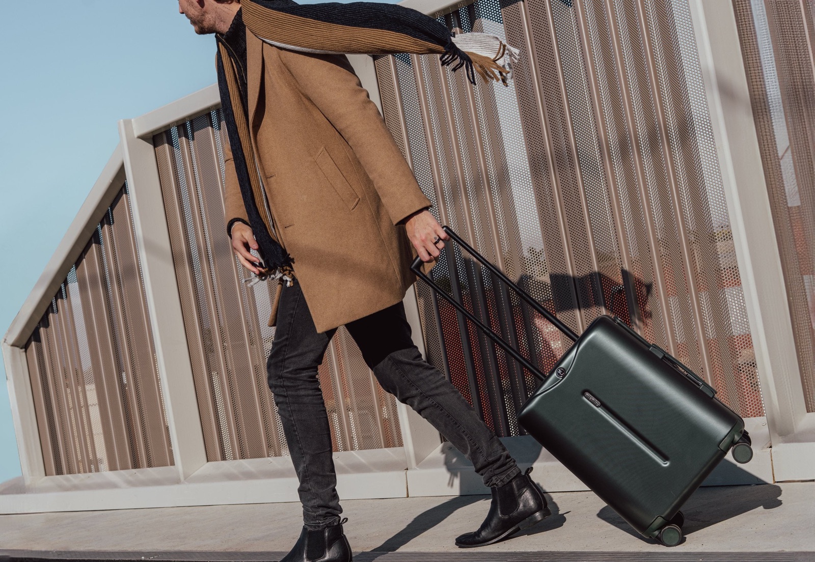 Traveller pulling a Forest Green MiaMily suitcase outdoors