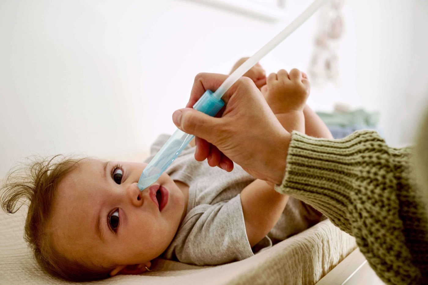 A baby with a Frida nose aspirator