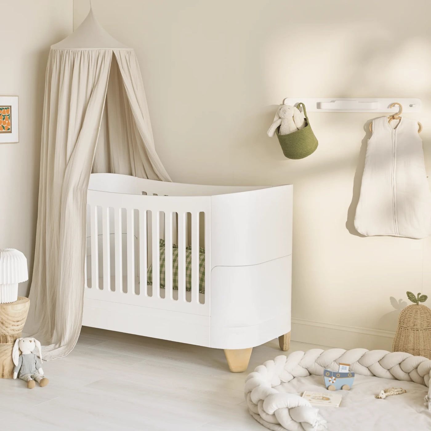 A calm nursery with a white Gaia Baby cot