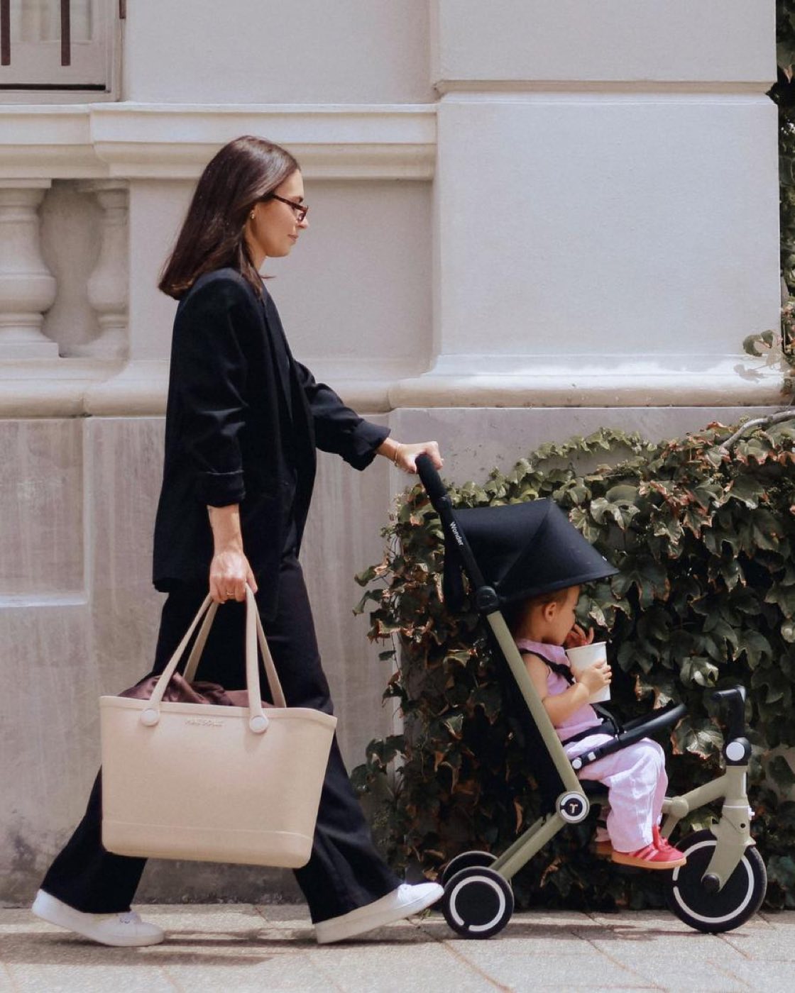 A parent walking with a child in a smarTrike