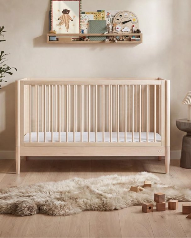 A timber cot in a nursery