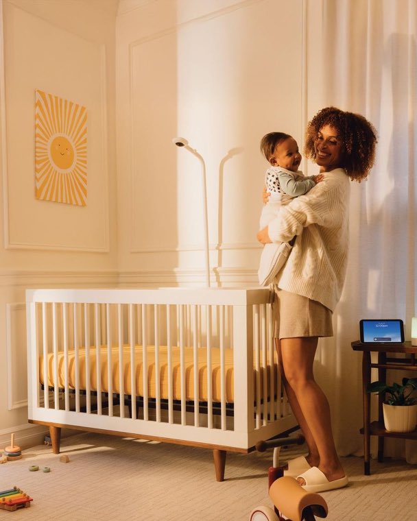 A mother holding her baby in a nursery